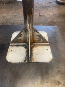 Custom fabricated bracing bar primed and painted on base plate