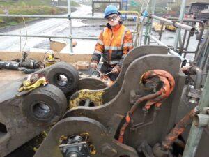 Engineer from Hickman Engineering working on some construction equipment