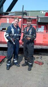 Two of Hickman Engineering's engineers on side working on a marine repair
