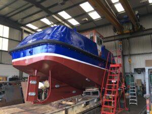 Under side view of a boat in for repair and re-painting with Hickman Engineering