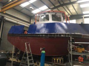 Side view of a boat in for repair with Hickman Engineering