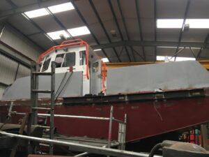 Side view of a boat in for repair with Hickman Engineering