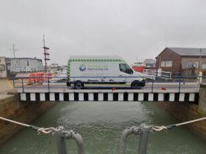 Road access bridge repaired and put back in place, shown supporting a Hickman Engineering van