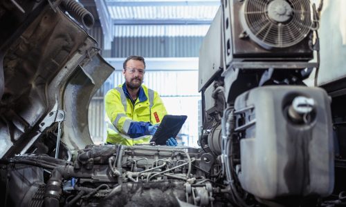 An engineer ticking off a checklist for urgent shipping repairs