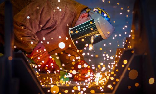 Welding and Fabrication Photograph showing a welder working on a steel fabrication