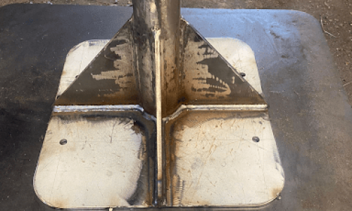 Custom fabricated bracing bar primed and painted on base plate